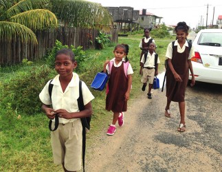 Children returning home from school on a rainy day 