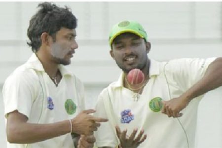 Spin twins Devendra Bishoo, left and Veerasammy Permaul with 18 wickets between them in the match yesterday bowled the Guyana Jaguars to victory over Jamaica at the Providence National Stadium