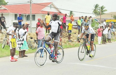 Team Evolution’s Orville Hinds reacts after winning yesterday’s 60-mile road race in Berbice. (Orlando Charles photo)