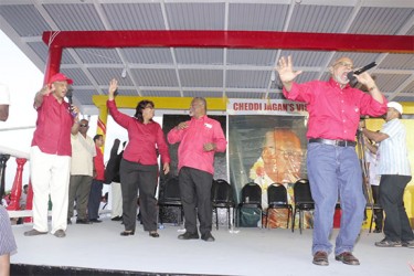 Ramotar does Bob Marley: President Donald Ramotar (right) rendering his version of `every little thing gonna be alright’ at yesterday’s PPP/C observance at Babu John, Port Mourant for the Jagans. His chorus comprised from left, PPP General Secretary Clement Rohee, prime ministerial nominee for the upcoming elections, Elisabeth Harper and Prime Minister Samuel Hinds. (Arian Browne photo) 