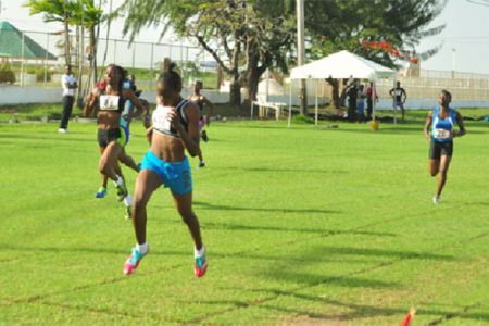 Kenisha Phillips powering across the line in the under-18 200m event yesterday. (Orlando Charles photo)
