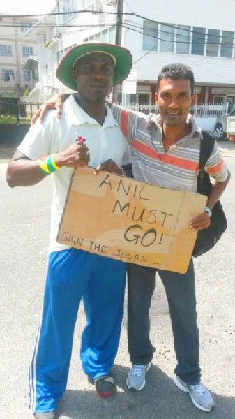 Courtney Crum-Ewing (left) and one of his Queen’s College schoolmates during the protets against Attorney General Anil Nandlall. Courtney Crum-Ewing (left) and one of his Queen’s College schoolmates during the protets against Attorney General Anil Nandlall. 