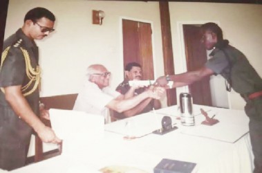 Courtney Crum-Ewing receiving his cadet graduation certificate from then President Cheddi Jagan