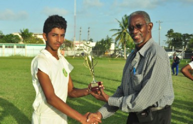 Raymond Perez receives his Man of the match award from the match referee.                    