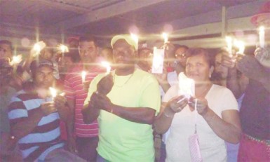 Stephen Daniels (centre) flanked by colleagues at the vigil  