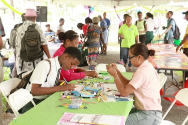 A student of the Bishops’ High School fills out a postcard to support the #UpForSchool campaign to encourage Guyanese girls to complete their schooling. (Photo by Arian Browne) Photo saved as Italy Caption: 