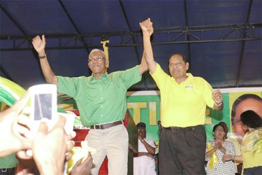 ‘We ready for the vote’: APNU+AFC Presidential and Prime Ministerial Candidates David Granger and Moses Nagamootoo do a jig at the coalition’s unity rally in Linden last night. (Photo by Arian Browne)