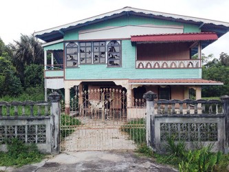  A cow shelters in the yard of one of the abandoned houses in the village. 