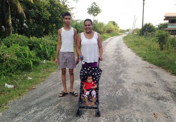 Chitra Devonish and her brother, Dinesh take a walk with her baby. 