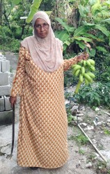 Farida Khan with a bunch of bananas she reaped in her yard