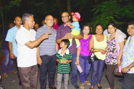 Head of State Donald Ramotar (second from left) and former President Bharrat Jagdeo (third from left) with some patrons of the State House fun day (GINA photo)