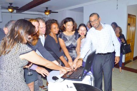 Minister of Natural Resources and the Environment, Robert Persaud (right) and United Nations Resident Representative to Guyana, Khadija Musa (fourth from right) and representatives of other countries press the button to launch the Guiana Shield Priority Setting Platform. (GINA photo)
           

