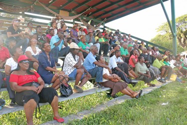 A section of those gathered for the vigil listen attentively to a speaker. About 250 persons turned up at the Parade Ground yesterday to pay tribute to slain political activist Courtney Crum-Ewing. (Photo by Arian Browne) 