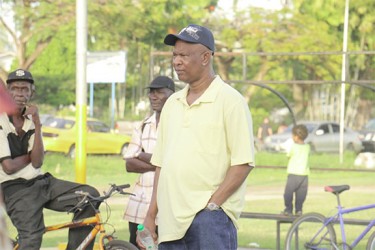 Clifford Crum-Ewing (right), the father of murdered political activist Courtney Crum-Ewing listening to a speech yesterday. A `silent’ vigil was held in honour of the father of three at the Parade Ground. During the event several persons addressed the approximately 250 persons who had gathered calling on them to condemn the killing and to ensure that they vote come May 11. (Photo by Arian Browne) 