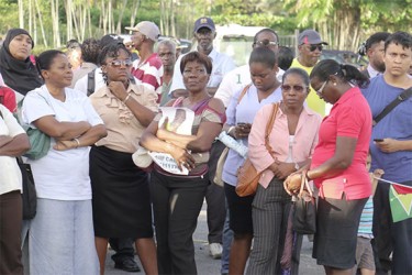 Some of the persons gathered for yesterday’s vigil in honour of murdered political activist Courtney Crum-Ewing at the Parade Ground. (Photo by Arian Browne)