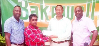 Kashi Muhammad, second from right receives the sponsorship cheque from Ragin Ganga of Bakewell while  Aubrey Major (right) and Frank ‘English’ Parris look on.