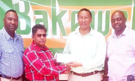 Kashi Muhammad, second from right receives the sponsorship cheque from Ragin Ganga of Bakewell while  Aubrey Major (right) and Frank ‘English’ Parris look on.
