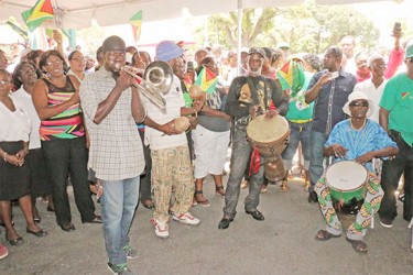  The drummers, trumpet player, and shak shak player, who played their instruments while the crowd sang Christian songs.  