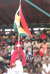 This man held the Guyana flag high at the viewing at Parade Ground.  