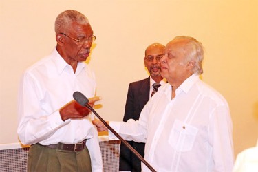 Presidential candidate David Granger (left) shares a moment with Sir Shridath Ramphal during Tuesday’s forum at the Pegasus Hotel. 