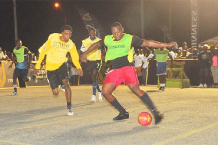 Action in the match-up between Plaisance-A (yellow) and Mahaicony United (green) in their group-D matchup of the Guinness Greatest of the Streets East Coast tourney
