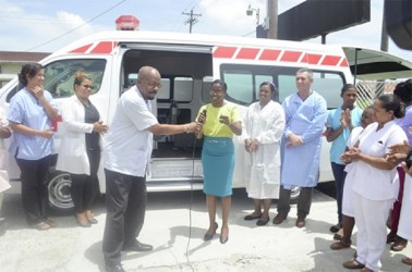 Minister of Local Government and Regional Development Norman Whittaker hands over the keys of the ambulance to Dr. Serena Bender of the Diamond Hospital. (Government Information Agency photo)