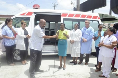 Minister of Local Government and Regional Development Norman Whittaker hands over the keys of the ambulance to Dr. Serena Bender of the Diamond Hospital. (Government Information Agency photo)