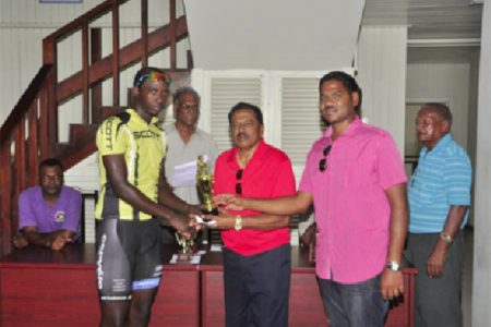 Akeem Arthur out pedaled a field of Guyana’s premier cyclists to win the third and final leg of the Cheddi Jagan Memorial road race series yesterday in Essequibo, but Hamza Eastman’s consistency enabled him to lift the overall trophy of this year’s event. By virtue of winning the first leg, placing fifth in the second leg and finishing second yesterday, the Team Coco’s standout was crowned this year’s champion.
In yesterday’s 55-mile trek, which pedaled off from Supenaam, proceeded to Charity and ended at Anna Regina, Arthur (2hr:07m:09s)  led Eastman and last year’s overall winner, Alanzo Greaves onto the podium.
Veteran rider, Robin Persaud and United Bike Shop’s Horrace Burrows were fourth and fifth respectively while Team Alanis’ Paul Choo-Wee-Nam placed sixth.
Yesterday’s race commenced as cool as the weather in the Cinderella County and there was not much theatrics on the upward journey.
When the wheelsmen turned back at Charity, the peloton was still mostly together save for a few stragglers and Orville Hinds who unfortunately suffered an early puncture.
There were several mini breaks on the way back to Anna Regina but the attackers were quickly wheeled in by the peloton.
The cyclists pretty much stuck to the script until Arthur solo attacked in the final 300m and held on for his first win of the season.
His attack went unchallenged as Eastman, the virtual leader heading into yesterday’s leg was content on preserving his one point lead ahead of Greaves.
Eastman’s tactic did not prove costly as he was able to edge out Greaves on the line in the bunch sprint.  Marica Dick (female), Julio Melville (Mountain Bike), Andrew Hicks (Junior) and Ralph Williams (veteran) were also categorical winners yesterday.
Notes: The sum of 38 riders started in yesterday’s race. The Memorial event is in it’s 18th year. It is held to commemorate the life and works of former president, Cheddi Jagan.
Jagan would have celebrated his 92nd birth anniversary yesterday. The initial leg was staged on the roadways of West Demerara while the second leg was held in Berbice.
Yesterday’s event was sponsored by S.Jagmohan Hardware Supplies and Constructing Services for the eighth consecutive year. (Emmerson Campbell)

