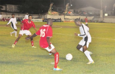 Action between New Amsterdam United in white and Riddim Squad FC in red during the opening matchup of the 25th edition of the Kashif and Shanghai tournament