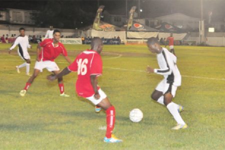 Action between New Amsterdam United in white and Riddim Squad FC in red during the opening matchup of the 25th edition of the Kashif and Shanghai tournament