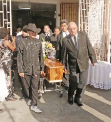 The coffin with the remains of businesswoman and cultural activist Margery Kirkpatrick being borne from the St Saviour’s Parish Church, Saffon Street yesterday. Her widower Dougal Kirkpatrick is at right.  Margery Kirkpatrick died on Saturday. She was an ardent advocate for the chronicling and preservation of Chinese culture here.