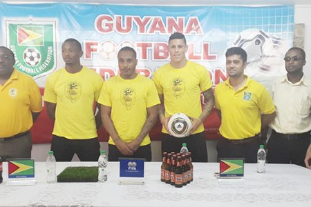 Newly recruited Golden Jaguars Neil Danns (3rd from left) and Matthew Briggs (4th from left) posing for a photo opportunity with members of the national team staff and Banks DIH Limited inclusive of head-coach Jamaal Shabazz (left) during their presentation to the media