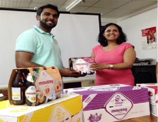 CEO of Southland International  Irzad Zamal handing over the Moussy beverage to Programme Manager of NAPS Dr. Shanti Singh 