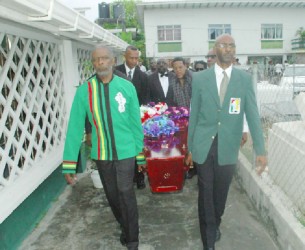 Charles Corbin, left and Garfield Wiltshire, right, lead the pallbearers delivering Shanomae Blackmore to her final resting place yesterday. 