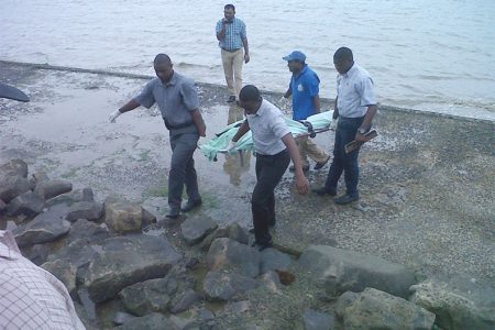 The body of Alicia Alli being retrieved from the seawall yesterday.