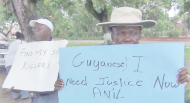 In this photo Crum- Ewing’s parents hold up their placards.