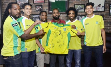 704 Sports Bar Project Manager Dustani Barrow (third from right) and members of the Golden Jaguars during Thursday’s presentation.  