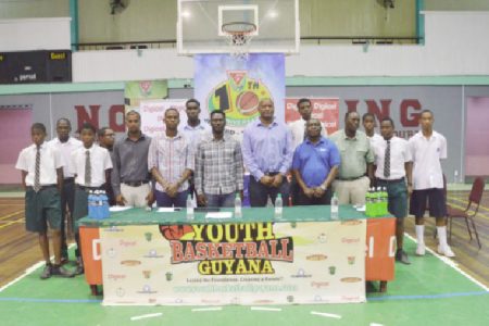 Members of the Youth Basketball Guyana (YBG) National Schools Championships launch committee alongside representatives of the Beharry Group of Companies, GABF, Banks DIH Limited and Digicel pose for a photo opportunity following the launch of the tourney yesterday.