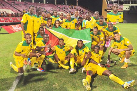 The victorious Golden Jaguars team after their 2-0 defeat of Grenada last night at the National Stadium, Providence. Inset Pernell Schultz. (Orlando Charles photos)