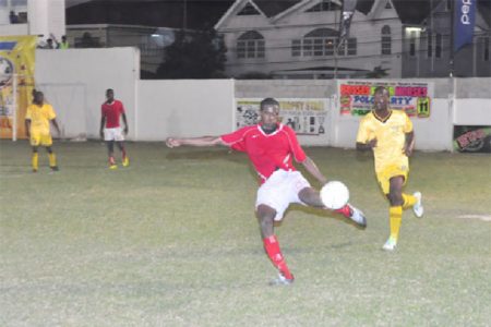 Riddim Squad’s Amos Ramsay attempting to clear the ball out of his team’s defensive third following an unsuccessful attack on their goal by Western Tigers 
