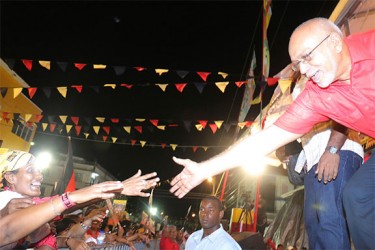 President Donald Ramotar (right) reaches out to a well-wisher