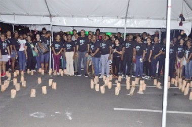 As the National Park was plunged into darkness for an hour to mark Earth Hour 2015, Minister of Natural Resources and the Environment Robert Persaud and others gathered to enjoy light from an alternative source. (GINA photo) 