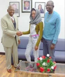  LINDENERS LINK. Consul General Evans congratulates champion sportswoman George as coach Moses Pantlitz looks on.