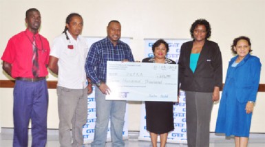 Petra Co-Director and tournament coordinator Troy Mendonca (3rd from left) receiving the sponsorship cheque from GT&T Senior Marketing Officer Anjanie Hackett while other members of the Petra Organization and GT&T look on. 