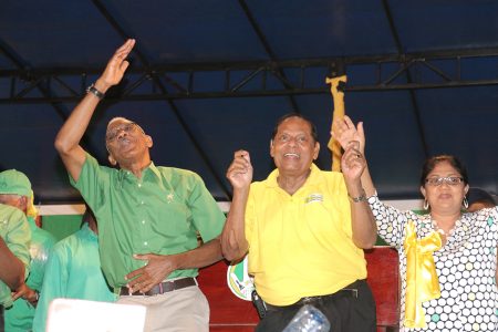 Presidential candidate David Granger (left) and Prime Ministerial candidate Moses Nagamootoo showing their moves last night at the  campaign launch in Linden. Nagamootoo’s wife Sita is at right.