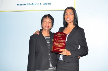 Indranie Chandarpal (left) and her daughter Gitanjali with the posthumous award for Navin Chandarpal