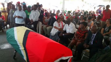 The casket with the remains of slain political activist Courtney Crum-Ewing was draped in the Guyana flag when it arrived at Parade Ground.