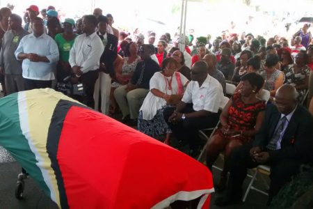 The casket with the remains of slain political activist Courtney Crum-Ewing was draped in the Guyana flag when it arrived at Parade Ground.