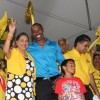 West Indies player Dwayne Bravo with Prime Minister Kamla Persad-Bissessar at the United National Congress’ Monday Night Forum in Debe.