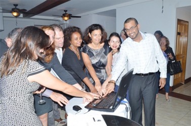 Minister of Natural Resources and the Environment, Robert Persaud (right) and United Nations Resident Representative to Guyana, Khadija Musa (fourth from right) and representatives of other countries press the button to launch the Guiana Shield Priority Setting Platform. (GINA photo)